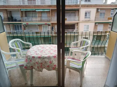 a table and chairs sitting on a balcony at Estudio Playa Cullera in Cullera