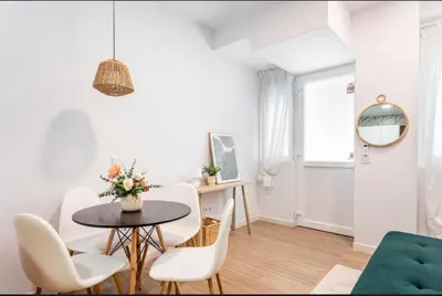 a white living room with a table and chairs at Lugre, Lovely flat close to center in Valencia