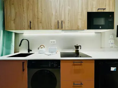 a kitchen with a sink and a washing machine at Stylish Design Studio in Valencia in Valencia