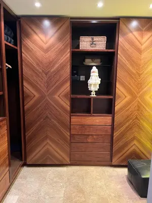 a closet with wooden paneled walls and wooden doors at Casa Dani in Sueca