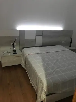a bedroom with a bed with a light above it at Villa conectada al mediterraneo, Infinity pool in Faro de Cullera