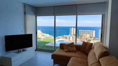 a living room with a couch and a large window at Villa conectada al mediterraneo, Infinity pool in Faro de Cullera