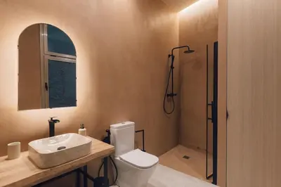 a bathroom with a toilet and a sink and a shower at Oasis suites ruzafa in Valencia