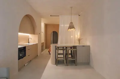 a kitchen with a counter and a bar with stools at Oasis suites ruzafa in Valencia