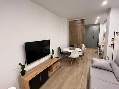 a living room with a television and a table at Loft en puerto de Valencia in Valencia