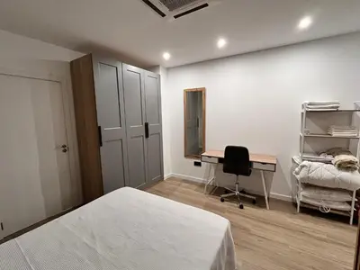 a bedroom with a bed and a desk and a chair at Loft en puerto de Valencia in Valencia