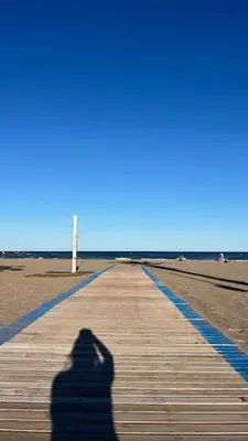 a shadow of a person taking a picture of the beach at Apartment near the beach in Valencia