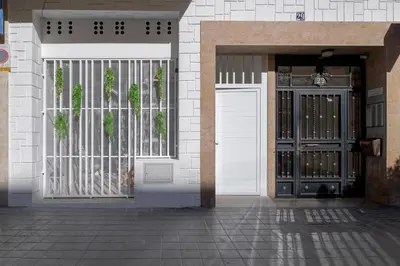 an entrance to a building with a white door and gate at RM29 Loft Valencia - Espacioso estudio con terraza en zona Ayora in Valencia