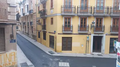 a white car parked in front of a building at Valencia Aparthotel HBB in Valencia