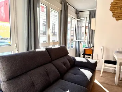a living room with a couch and a table at Reinapart Cabanyal in Valencia