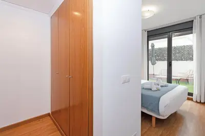 a bedroom with a bed and a wooden cabinet at GuestReady - Lovely home near the beach in Valencia