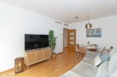 a living room with a couch and a tv on a stand at GuestReady - Lovely home near the beach in Valencia