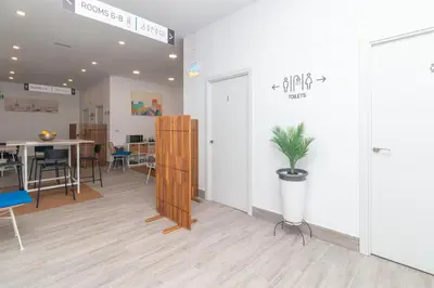 a room with a table and a potted plant in it at Moreno Rooms by BET Apartments in Valencia