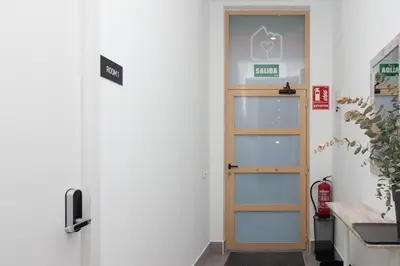 a door in a room with a sign on the wall at Moreno Rooms by BET Apartments in Valencia
