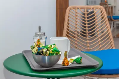 a plate with a bowl of candy on a table at Moreno Rooms by BET Apartments in Valencia