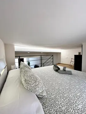a bedroom with a large white bed with pillows at Encanto Rural en Requena in Requena