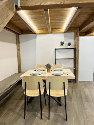 a dining room with a wooden table and chairs at Encanto Rural en Requena in Requena