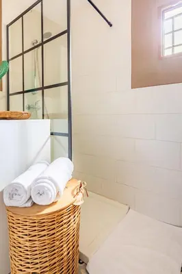 a wicker basket with towels in a bathroom at Les moreres a space for tranquility in Valencia