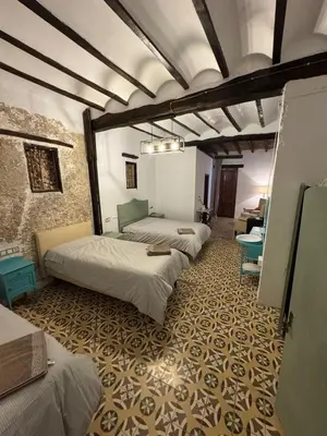 a row of beds in a room with a wall at La Replaceta in Segorbe