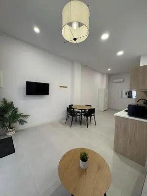 a living room with a table and some chairs at Centric Loft near Arts & Science in Valencia