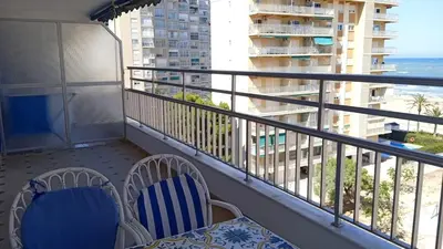two chairs and a table on a balcony with the ocean at Cisne! Vistas al mar, piscina y garaje in Cullera
