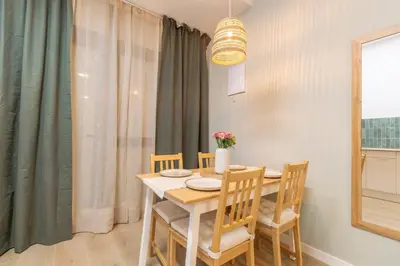 a dining room with a table and four chairs at Paradise Suite - Cómodo y acogedor - Conectado con Aeropuerto, Playa y Centro in Valencia