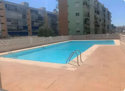 a large swimming pool in an apartment building at Precioso estudio en la playa norte de Valencia in Puebla de Farnals