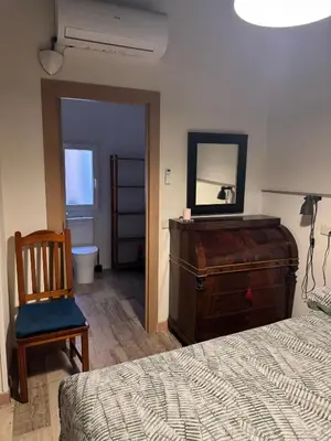 a bedroom with a bed and a dresser and a mirror at Miguelete tower & 4th FLOOR & City center and no elevator in Valencia