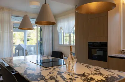 a kitchen with a table with a wine glass on it at Casa Roka in Alberique