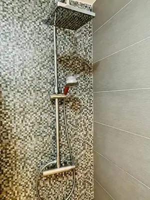 a shower in a bathroom with a tile wall at Casa Calma - Modern Apartment, Perfect Location - All you need for a great time in Valencia in Valencia