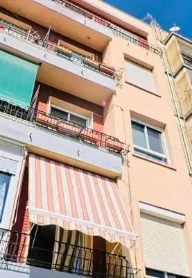 an apartment building with a balcony with an awning at Casa Calma - Modern Apartment, Perfect Location - All you need for a great time in Valencia in Valencia