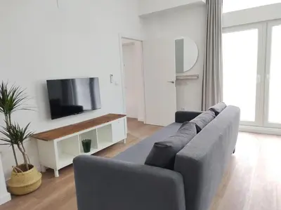a living room with a couch and a flat screen tv at District Key - Valencia, Plaza del Cedro in Valencia