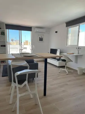 a white room with a table and chairs in it at More then a loft in Godella
