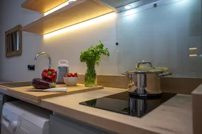 a kitchen counter with a sink and vegetables on it at Nomad Haux Mestalla Apartments in Valencia