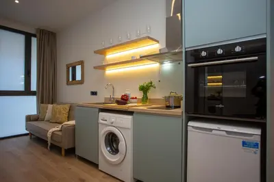 a kitchen with a washing machine and a washer at Nomad Haux Mestalla Apartments in Valencia