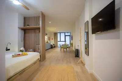 a bedroom with a bed and a tv on a wall at Nomad Haux Mestalla Apartments in Valencia