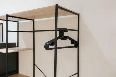 a black shelf with a wooden top on a wall at Chic & Cozy Stay in Valencia in Valencia
