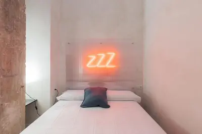 a bed with a neon sign on the wall at Chic & Cozy Stay in Valencia in Valencia