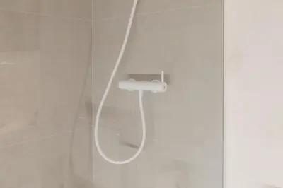 a shower with a white hose in a bathroom at Trendy Retreat in Valencia in Valencia