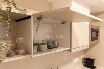 a kitchen with white cabinets and a microwave at Royal Flats in Valencia