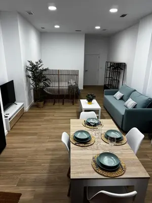 a living room with a couch and a table at Apartamento playa malvarrosa in Valencia