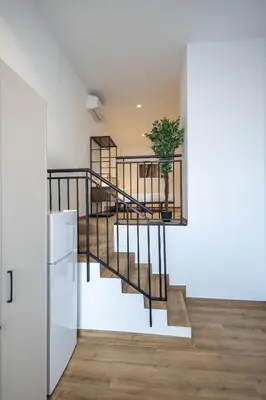 a staircase in a house with a potted plant at Les Arts Turia by Concept Flats in Valencia