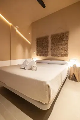 a bedroom with a large white bed with lights on it at Abastos by Concept Flats in Valencia