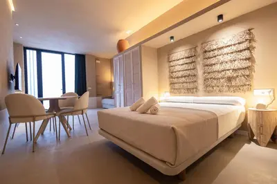 a bedroom with a bed and a table and chairs at Abastos by Concept Flats in Valencia