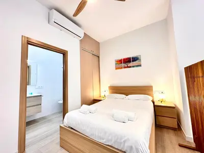 a kitchen with stainless steel appliances and a table at Valentia Modern and Comfortable Beachside Style in Valencia