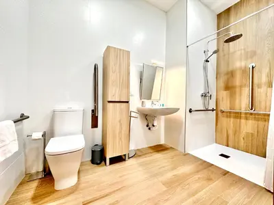 a bathroom with a toilet and a sink at Valentia Modern and Comfortable Beachside Style in Valencia