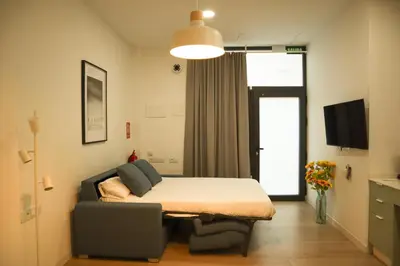 a living room with a table and a couch at Valentia Modern and Comfortable Beachside Style in Valencia