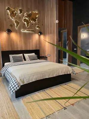 a bedroom with a bed with a world map on the wall at New Loft Rusafa in Valencia