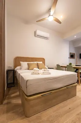 a bedroom with a bed with a ceiling fan at Porto by Concept Flats in Valencia