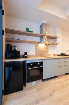 a kitchen with a black and white counter top at Porto by Concept Flats in Valencia